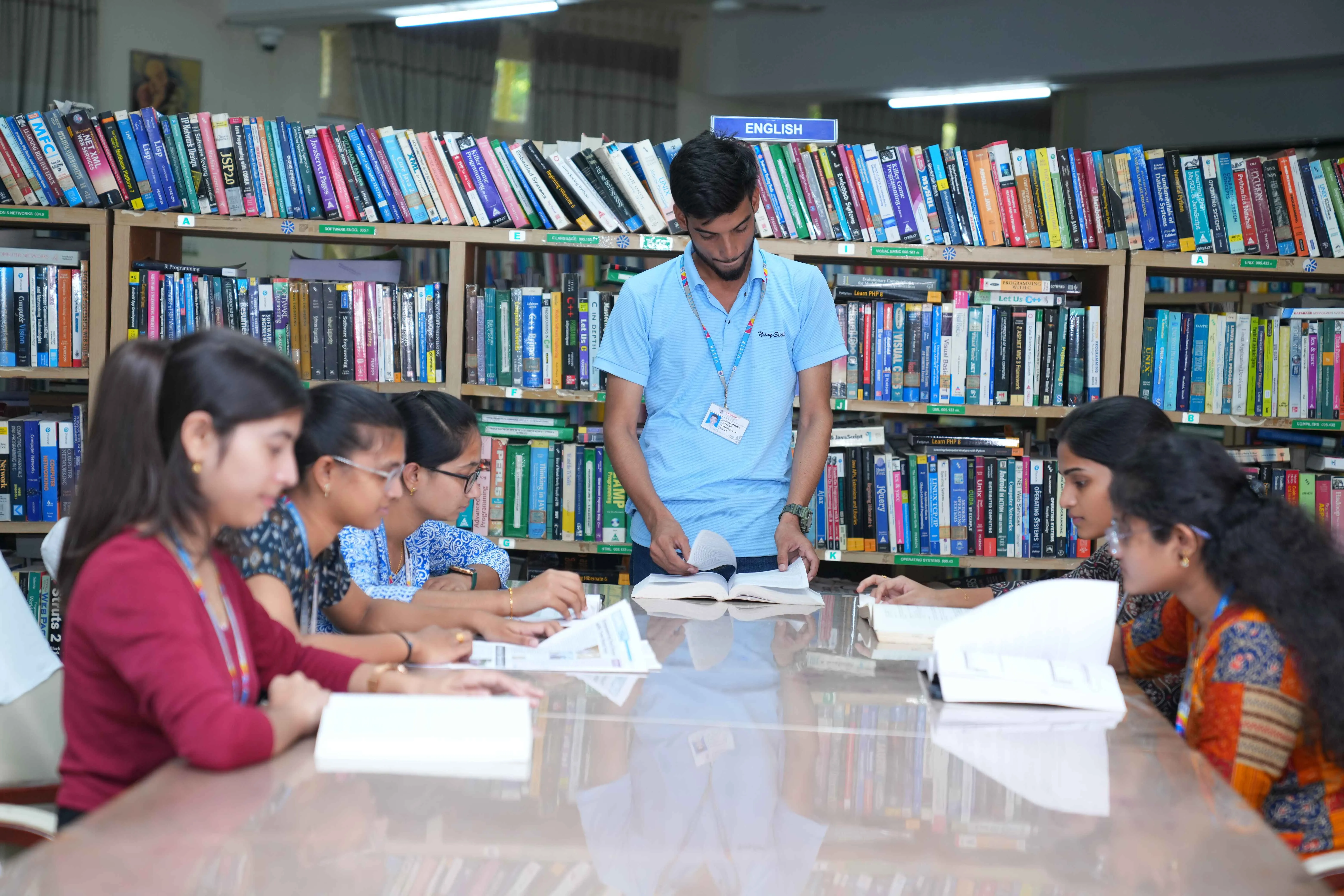 Students reading together in the English section of the library
