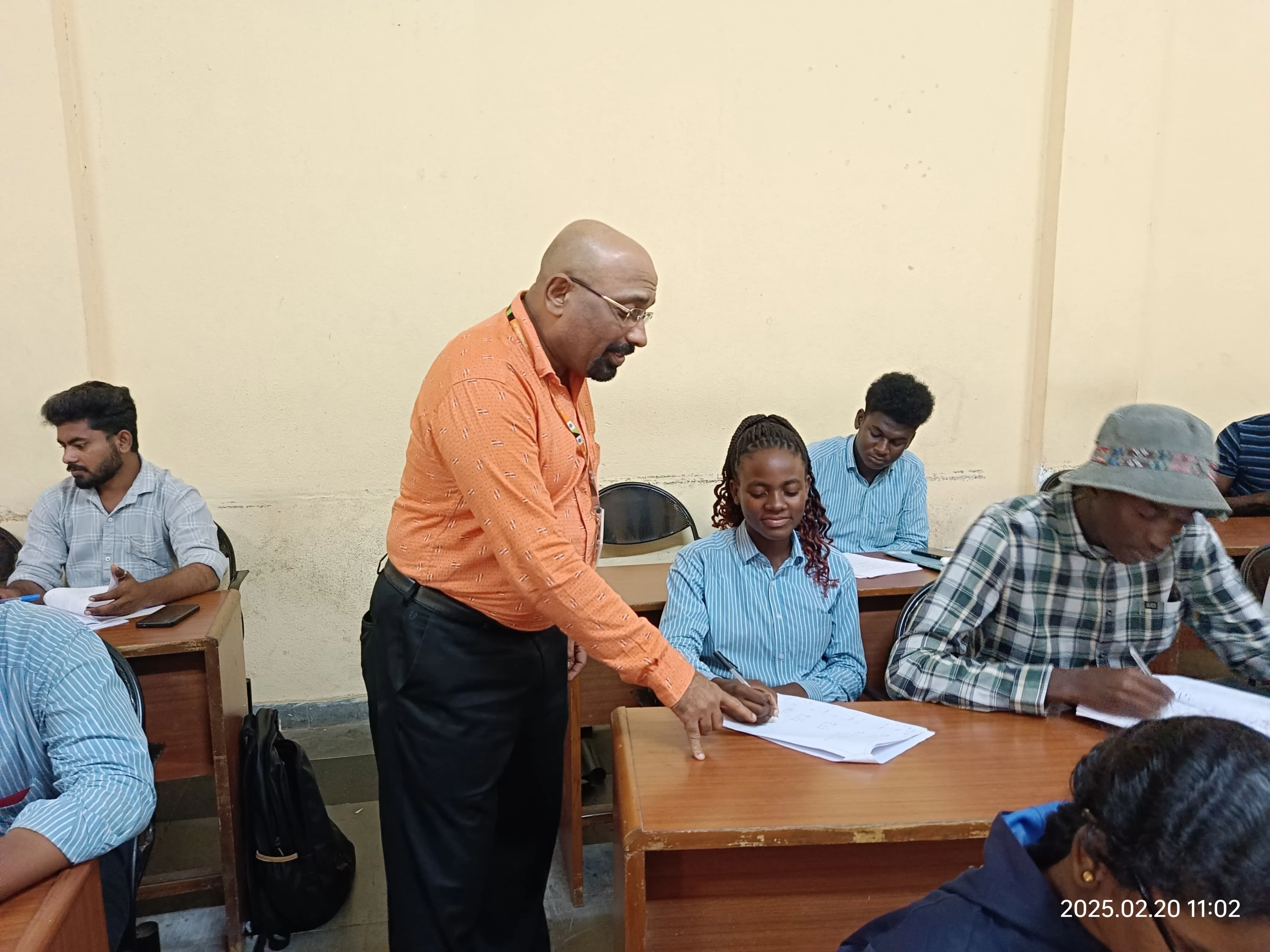 Faculty mentoring students in a classroom